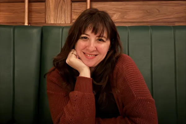 a woman sits at a table